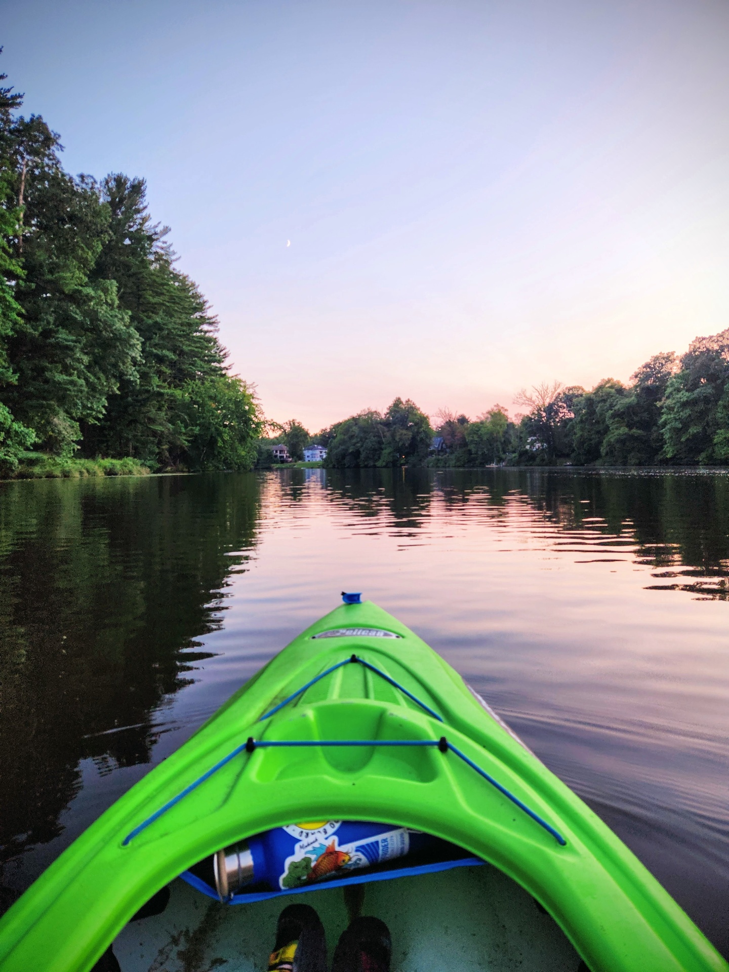 A kayak on still water at sunset
